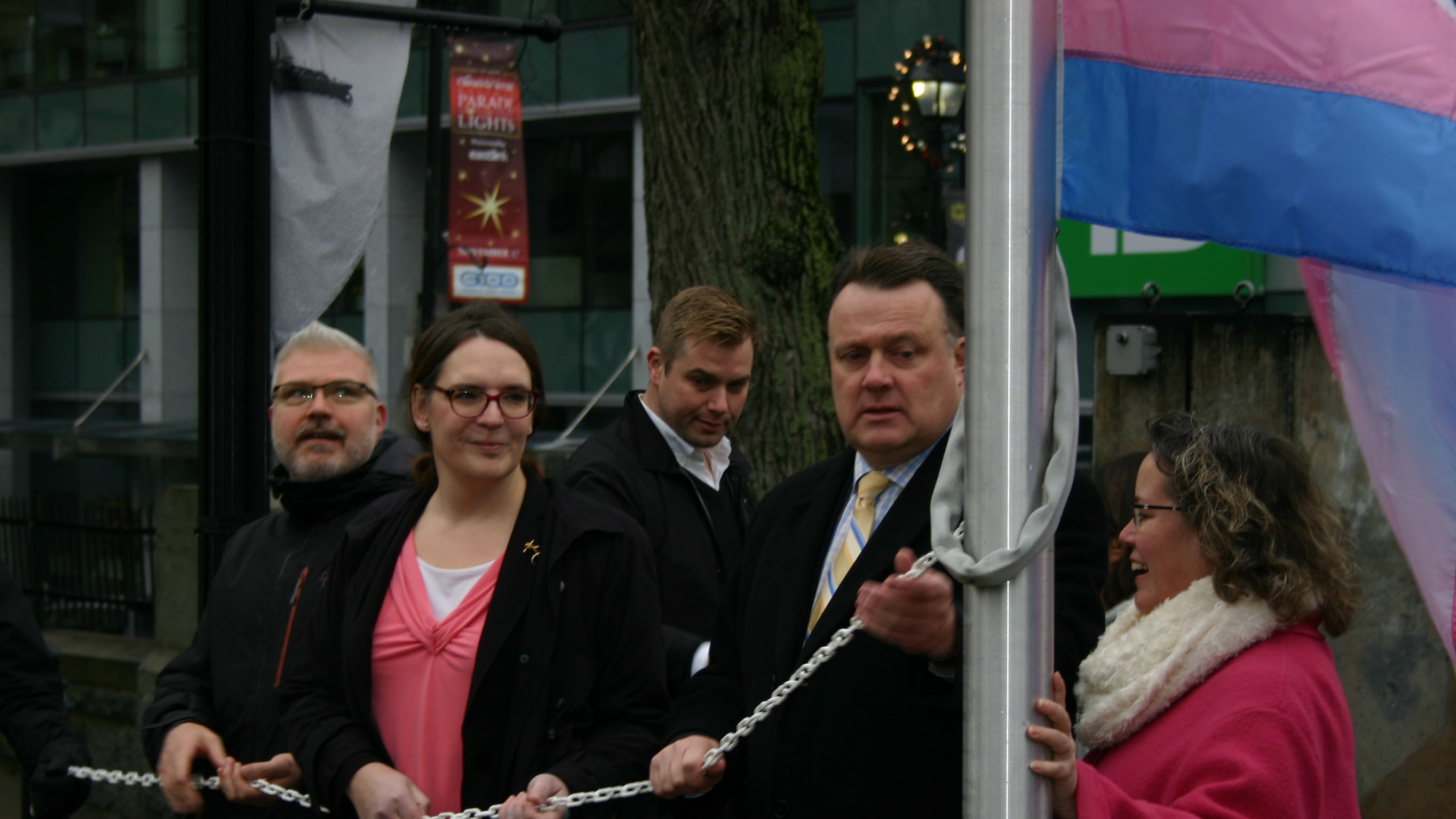 Shawn Cleary, Jessica Dempsey, and Mayor Mike Savage raise the transgender flag outside of Halifax City Hall on Tuesday. Nov. 20 is Trans Day of Remembrance.