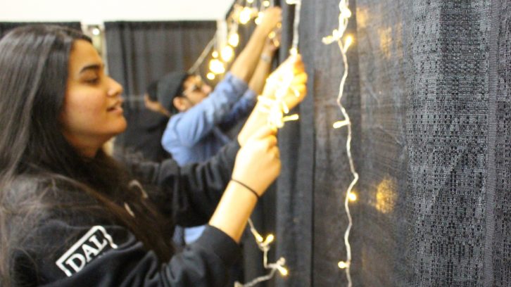 Volunteers untangle lights to prepare for Diwali. 

