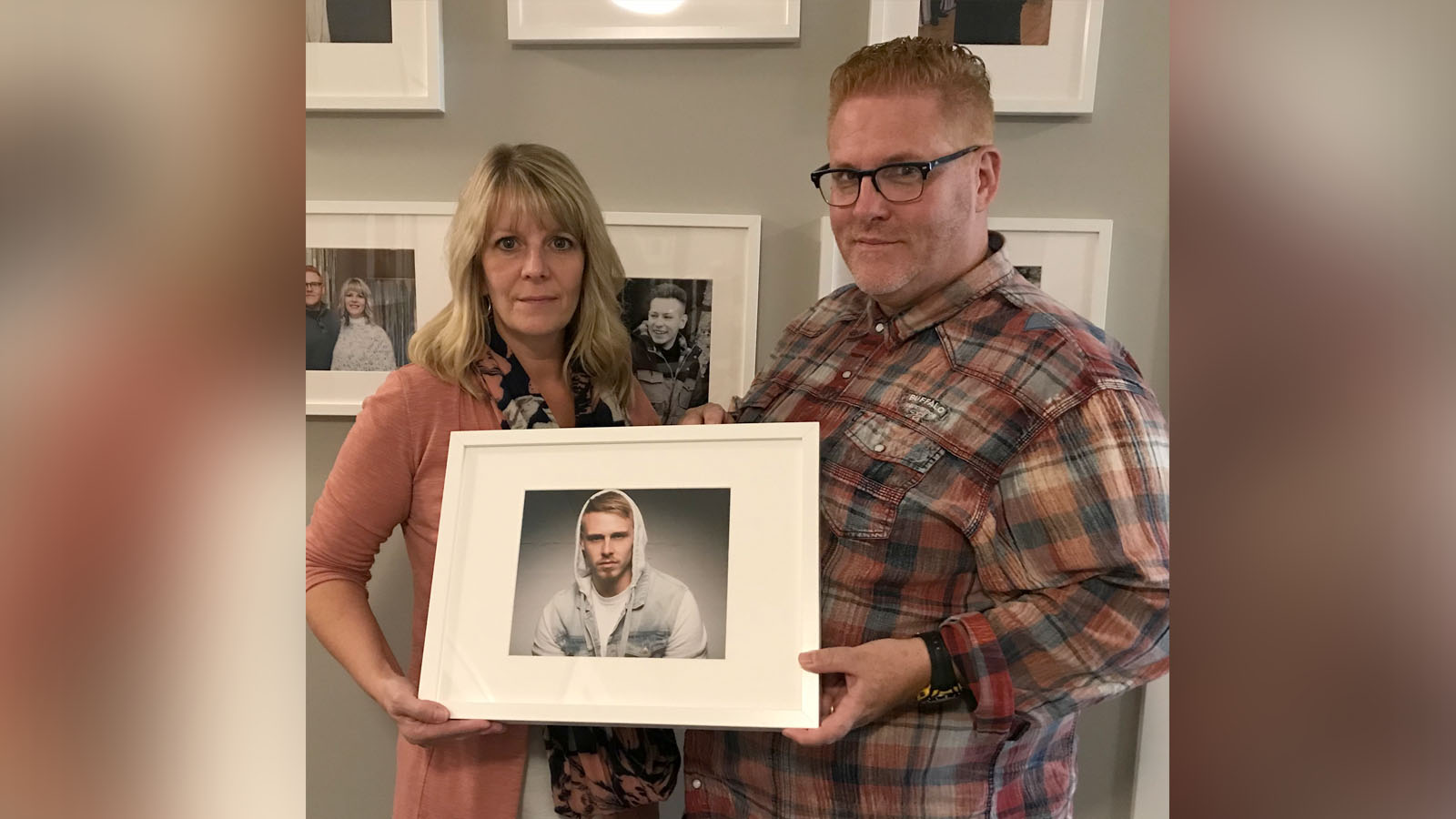 Conway family holds deceased son's photo