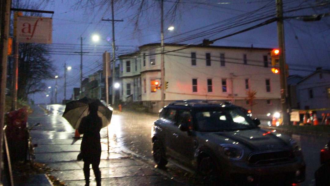 A pedestrian walks in the rain in Halifax’s Hydrostone neighbourhood