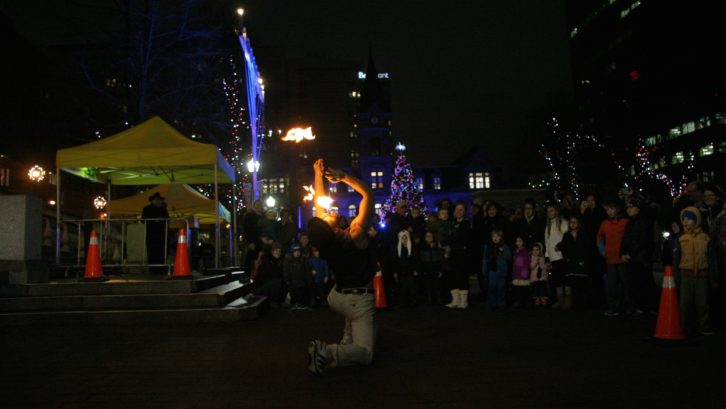 Kyle Scott performs at the side of the menorah at Halifax Grand Parade on Monday night. 