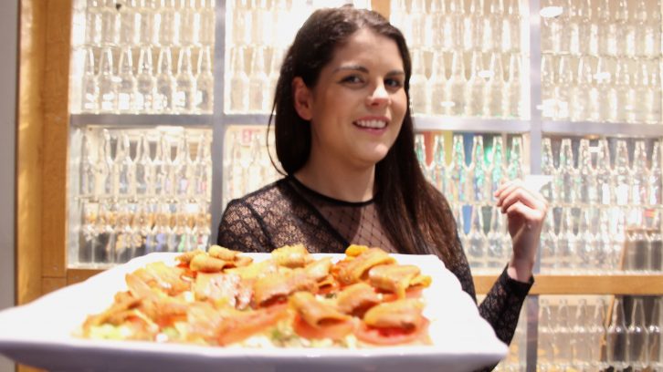 Real Fake Meat owner Lauren Marshall with a plate of BLT sliders made from coconut bacon.
