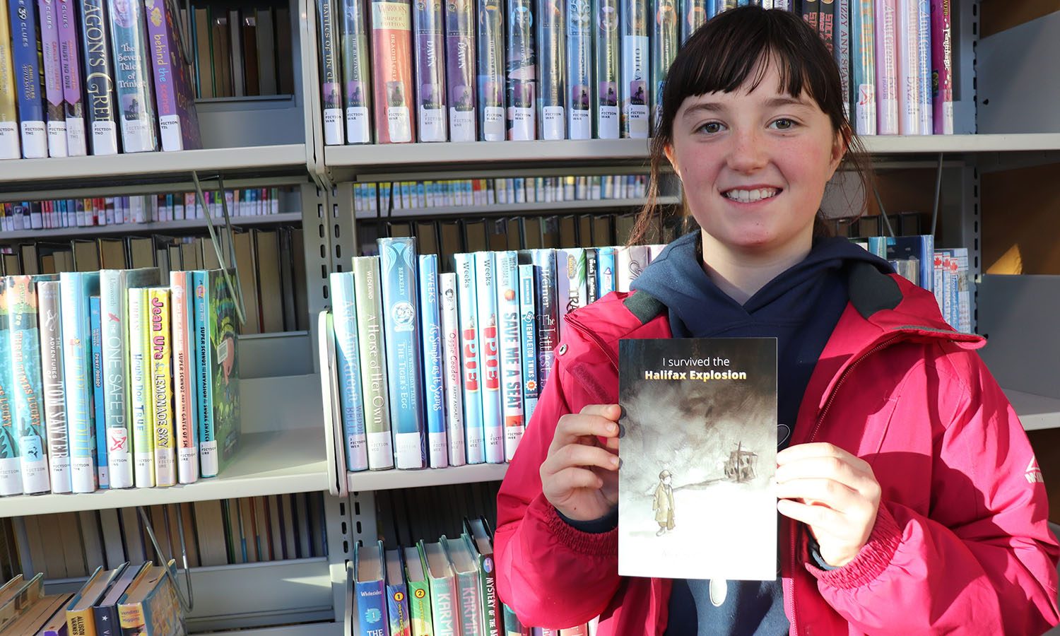 Alice Roebotham, 10, holds her book I Survived the Halifax Explosion.