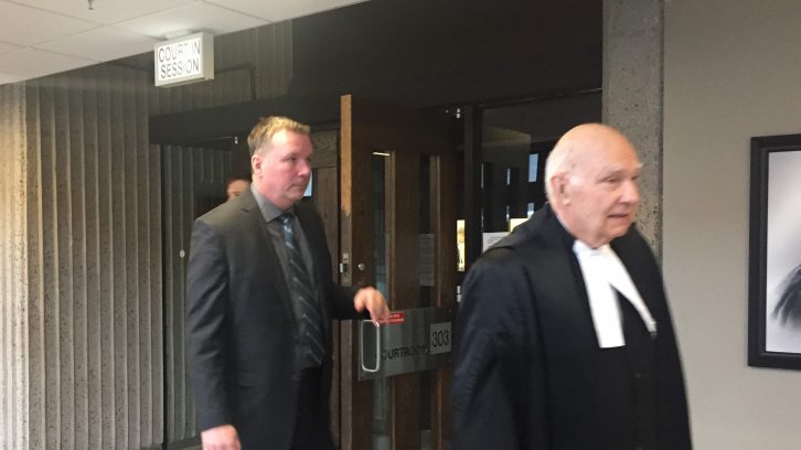 Craig Robert Burnett (left) leaving court room on the fourth day of his trial.
