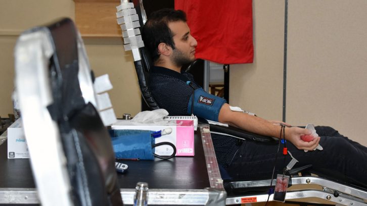 Ummah community member Hasan Sinan feels good after giving blood.