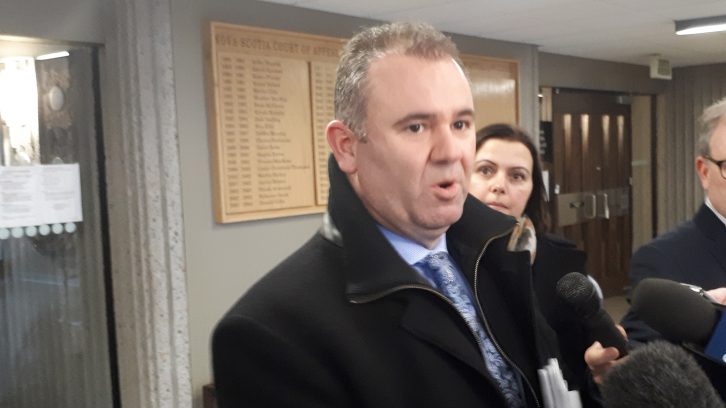 George Kinsman from Ernst and Young talks to reporters in a scrum. His firm was appointed as the monitor for QuadrigaCX. 