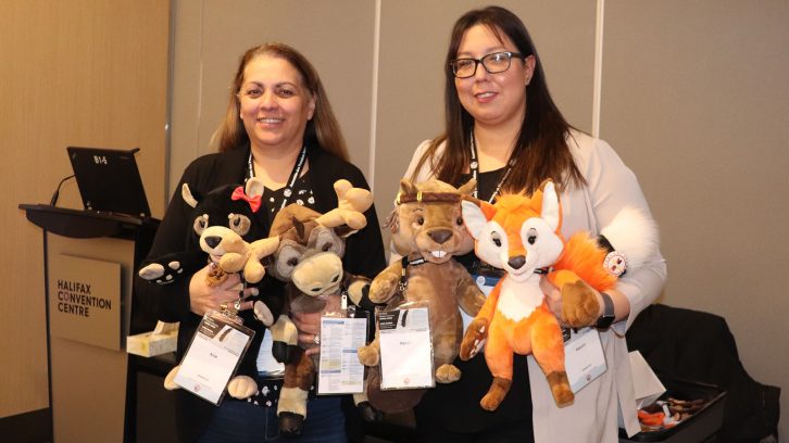 Yoland Denny (left) and Blaire Gould (right) hold up the four puppets Aliet, Antle, Pikto'l and Kalolin.
