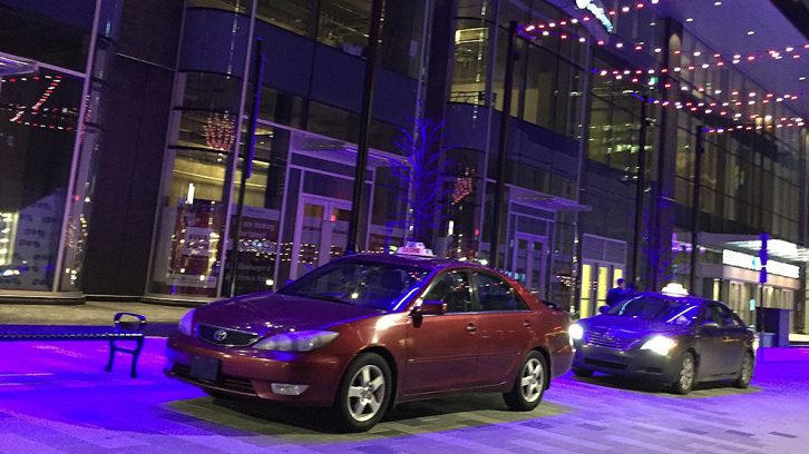 Two taxis waiting outside of the Halifax Convention Centre.