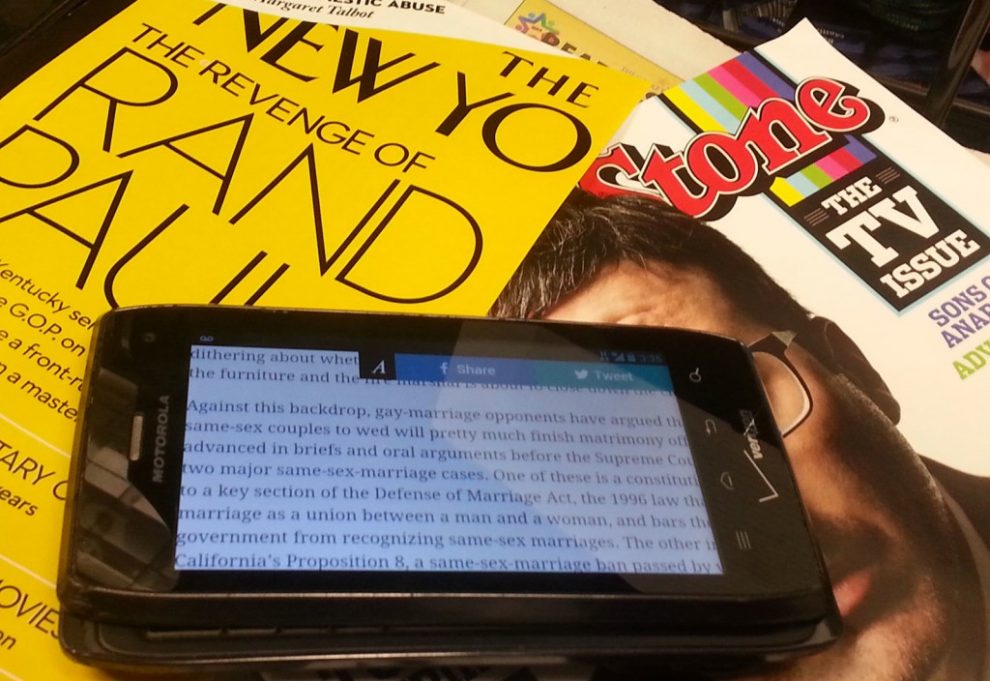 Two types of magazines: the scroll-able smartphone on top of traditional print.