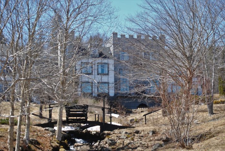 Castle Gracie is seen through trees in mid-April,2019