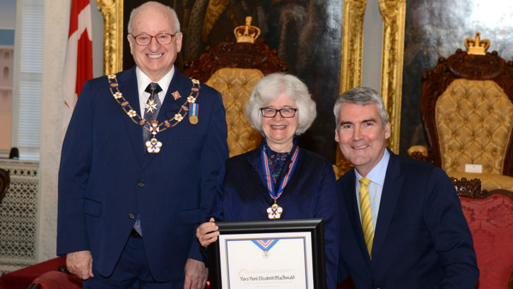 Dr. Noni MacDonald receiving her award alongside Lt.-Gov. Arthur J. LeBlanc and Premier Stephen McNeil.