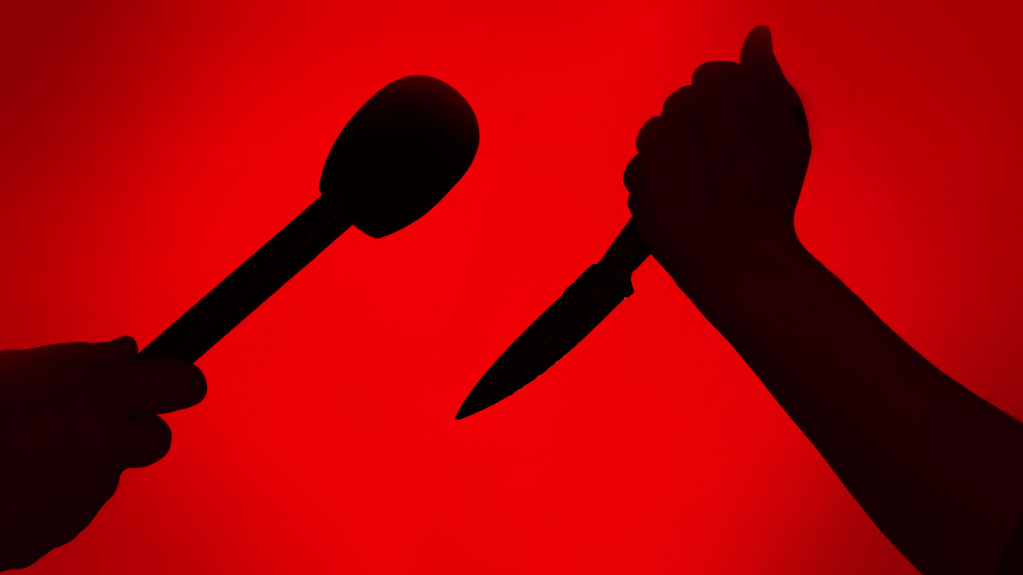 A person with a knife is seen with a person holding a microphone