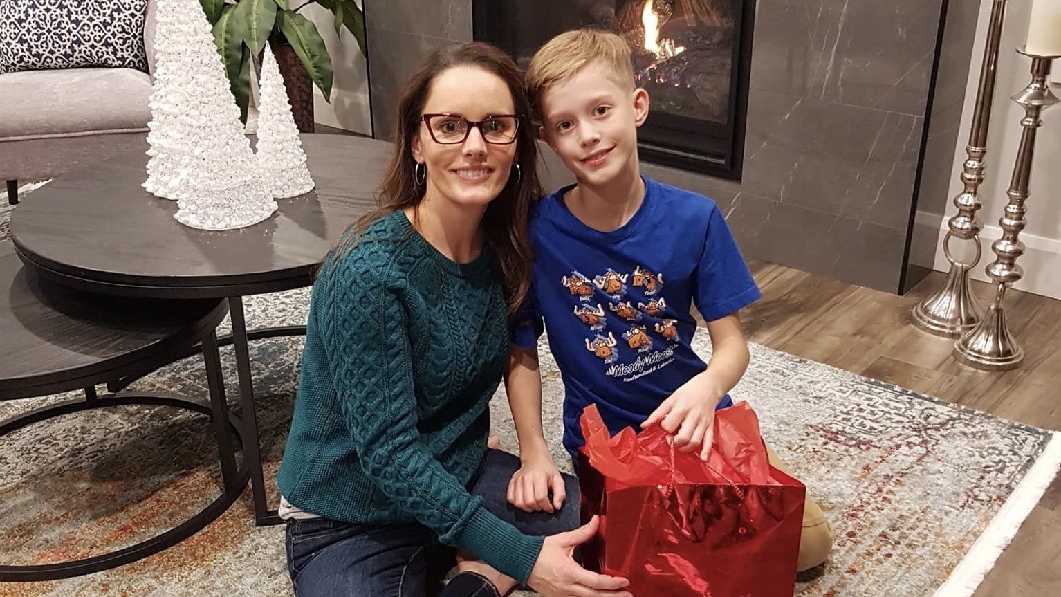 Tammy Clarke and son Tanner. Clarke says collecting and wrapping purses is her "little tradition to give back." 
