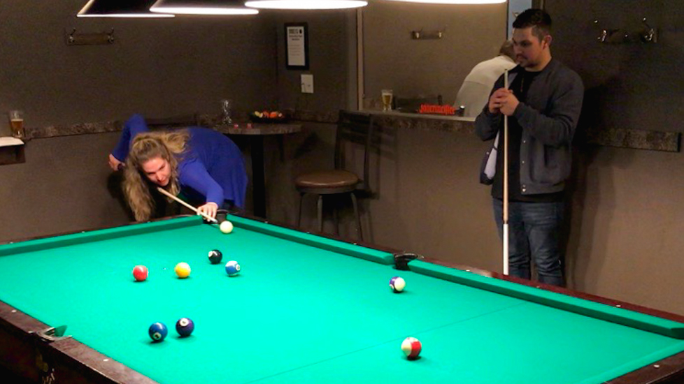 Jean-eva Dickie and Winston Guitar play pool during a speed friending event last Tuesday. 
