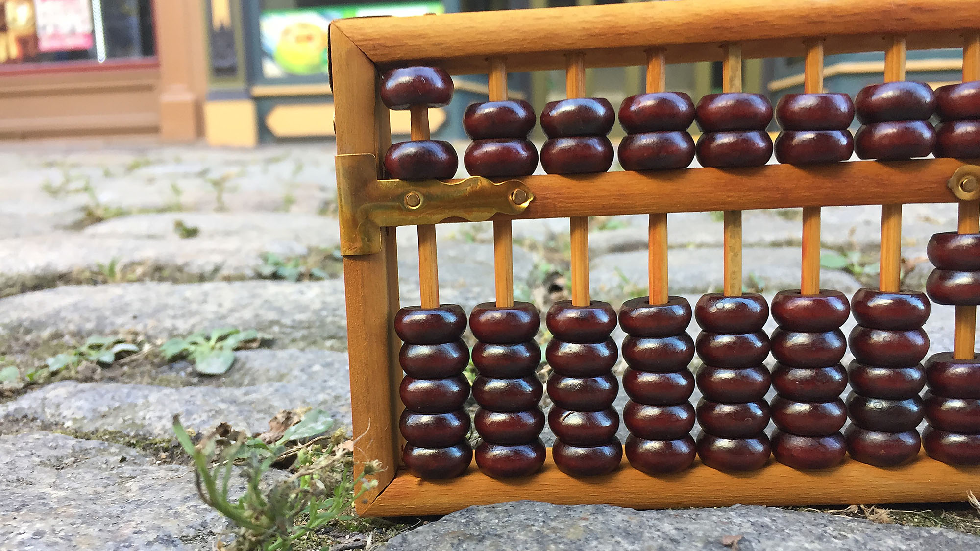 An abacus sits on the ground.