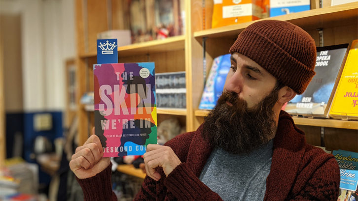 Paul MacKay, who manages the King's Co-op Bookstore, holds an advanced copy of Desmond Cole's The Skin We're In.