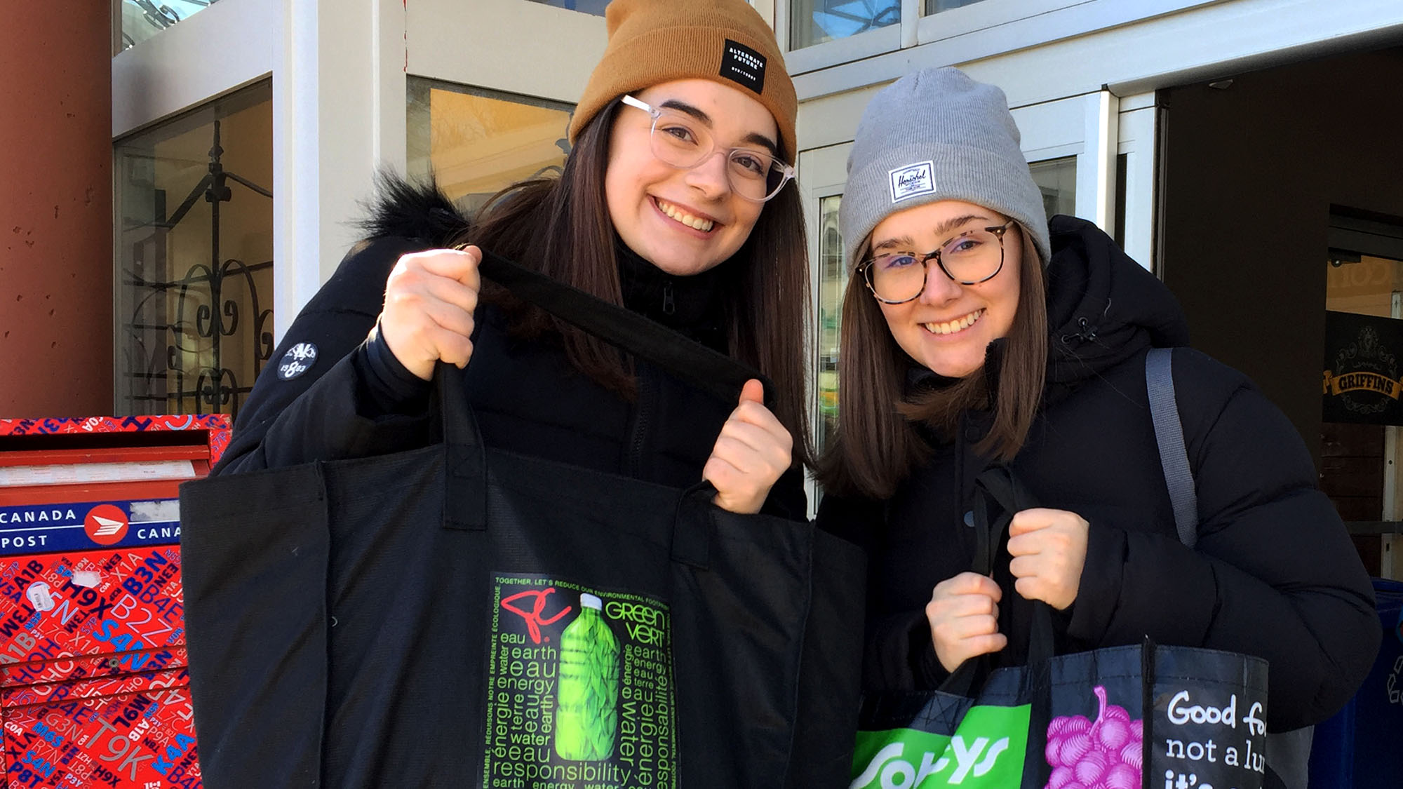 MacKayla Williams (right) and Maddy Nugent (left) came prepared for Sobeys' switch from plastic to reusable bags.