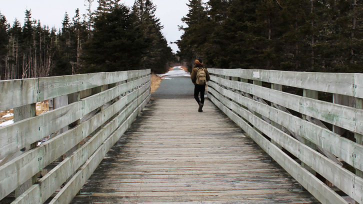 Man walks along the Atlantic View Trail in Lawrencetown, NS.