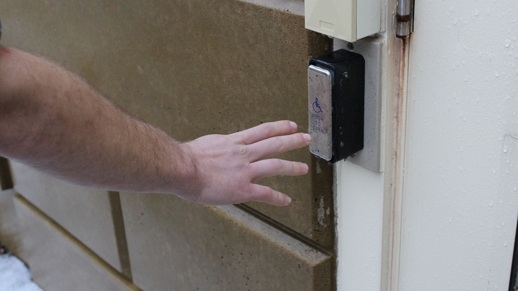 Photo illustration of someone using automatic door.