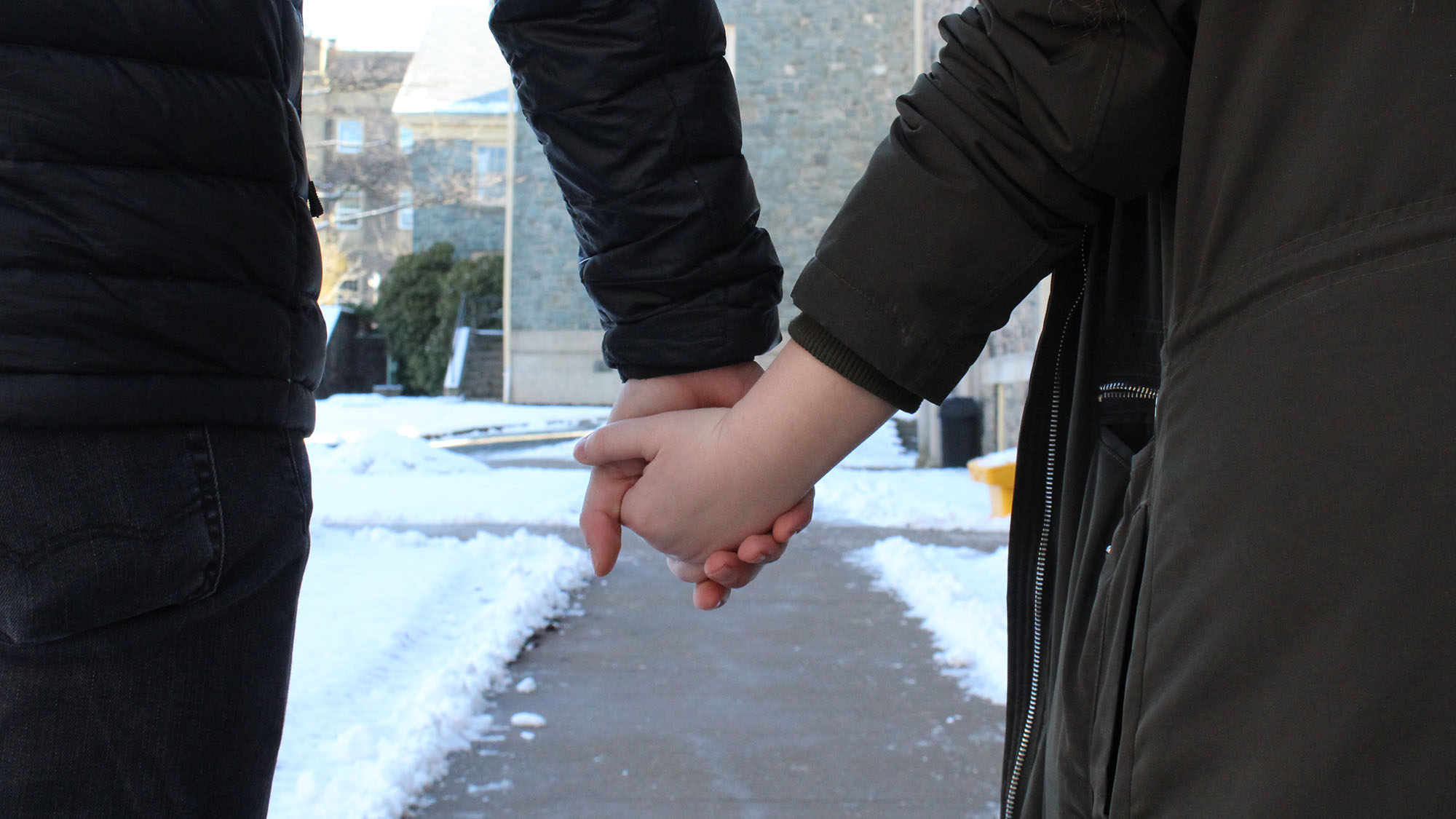 Photo illustration of two people holding hands