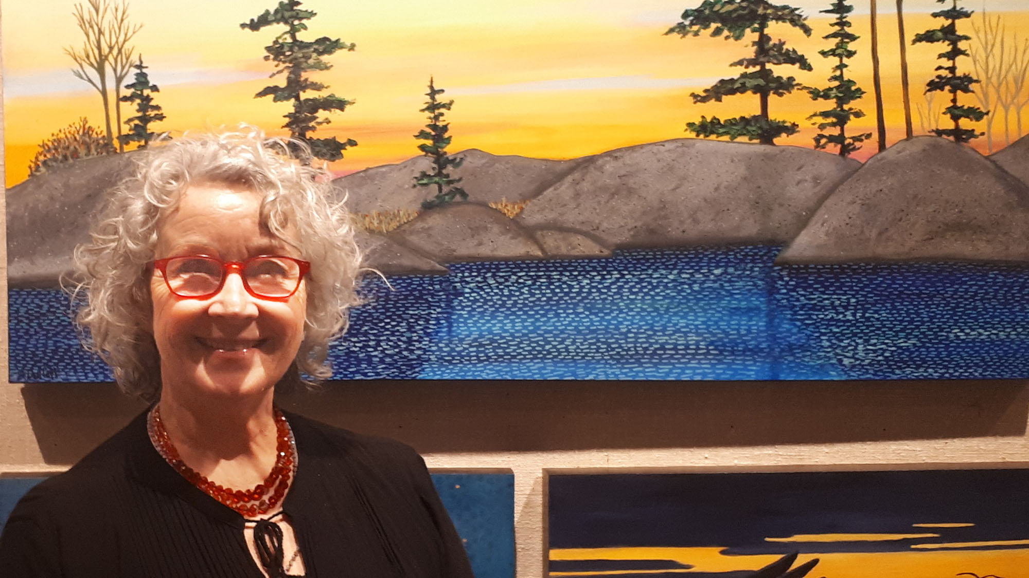 Shelagh Duffett stands in front of her paintings in the Chase Gallery in Halifax on Saturday. 