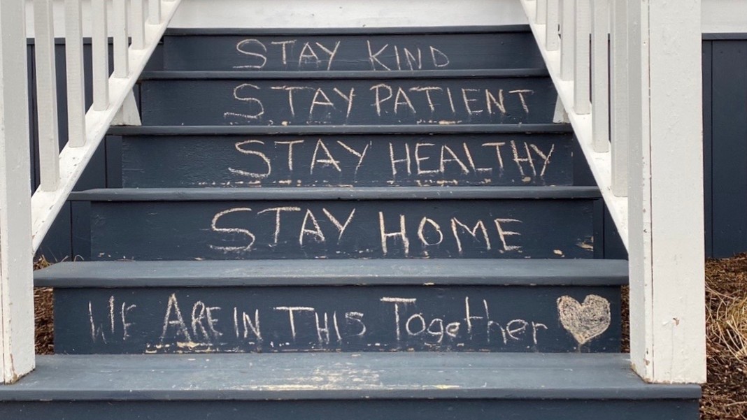 A message about staying home and safe on the front steps of a house in south-end Halifax.