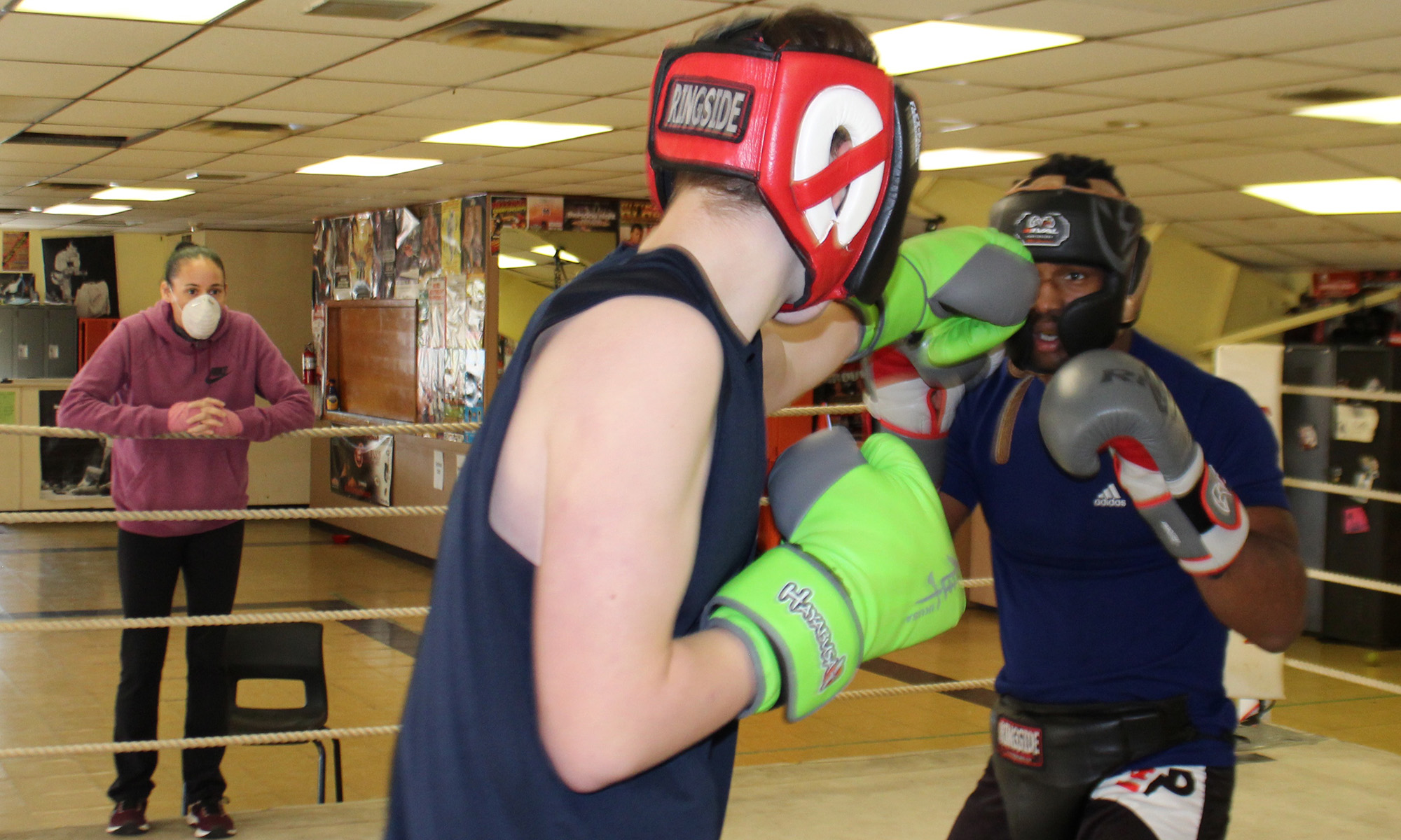 Bridget Stevens coaches two of her boxers, John-Michael Forrestall and Andrew Thomas at her gym.