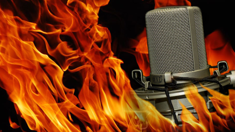 A microphone is surrounded by fire in this photo illustration.