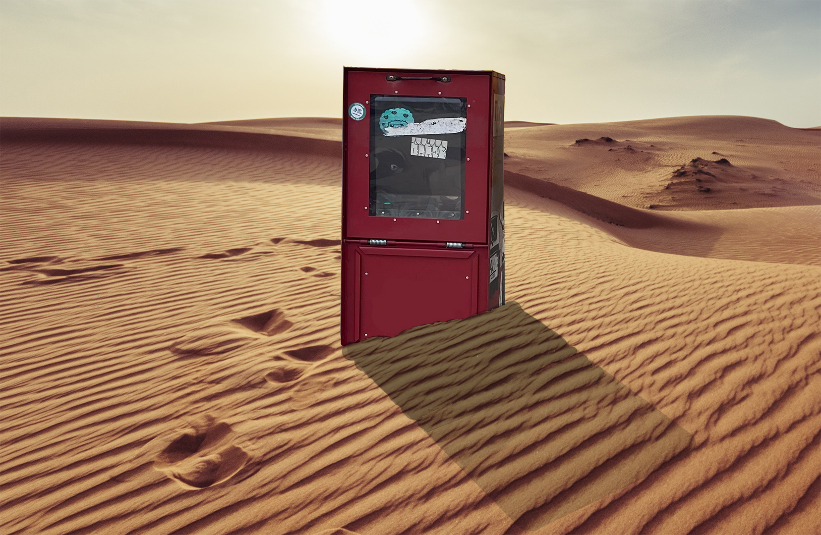 A newspaper box is seen in a desert.