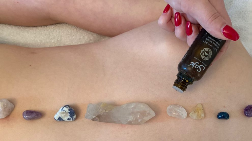 Re-enactment of a crystal aromatherapy massage, a treatment that involves essential oils (aromatherapy) and crystals that are advertised to balance energies in the body. 