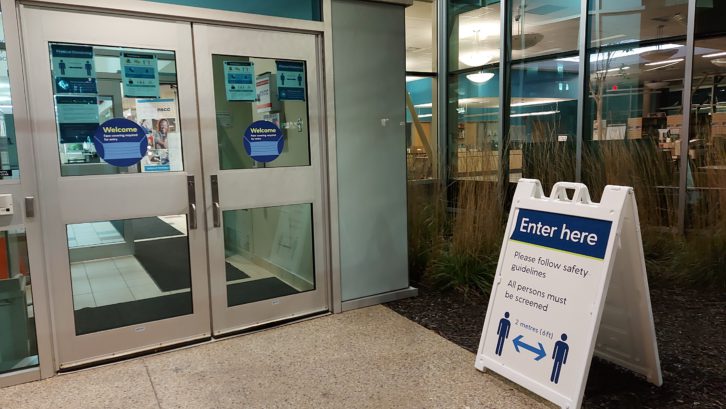 Signs in front of NSCC's Institute of Technology Campus remind visitors of public health guidelines. 