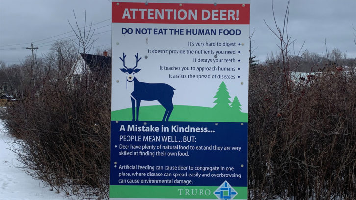 This sign advises deer to not eat human food, as it's a dangerous mistake in kindness.