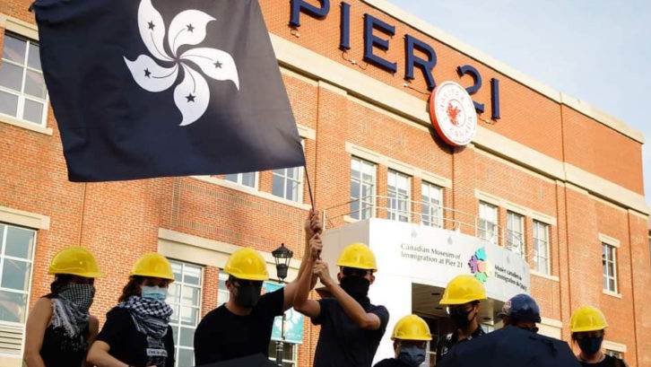 Members of Halifax-Hong Kong Link pose in front of Pier 21, a Canadian symbol of refuge
