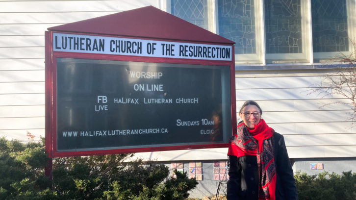 Pastor Kimberlynn McNabb  in front of the Lutheran Church of the Resurrection.