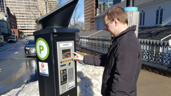 A man uses one of the digital parking stations in downtown Halifax on Feb. 3, 2020.