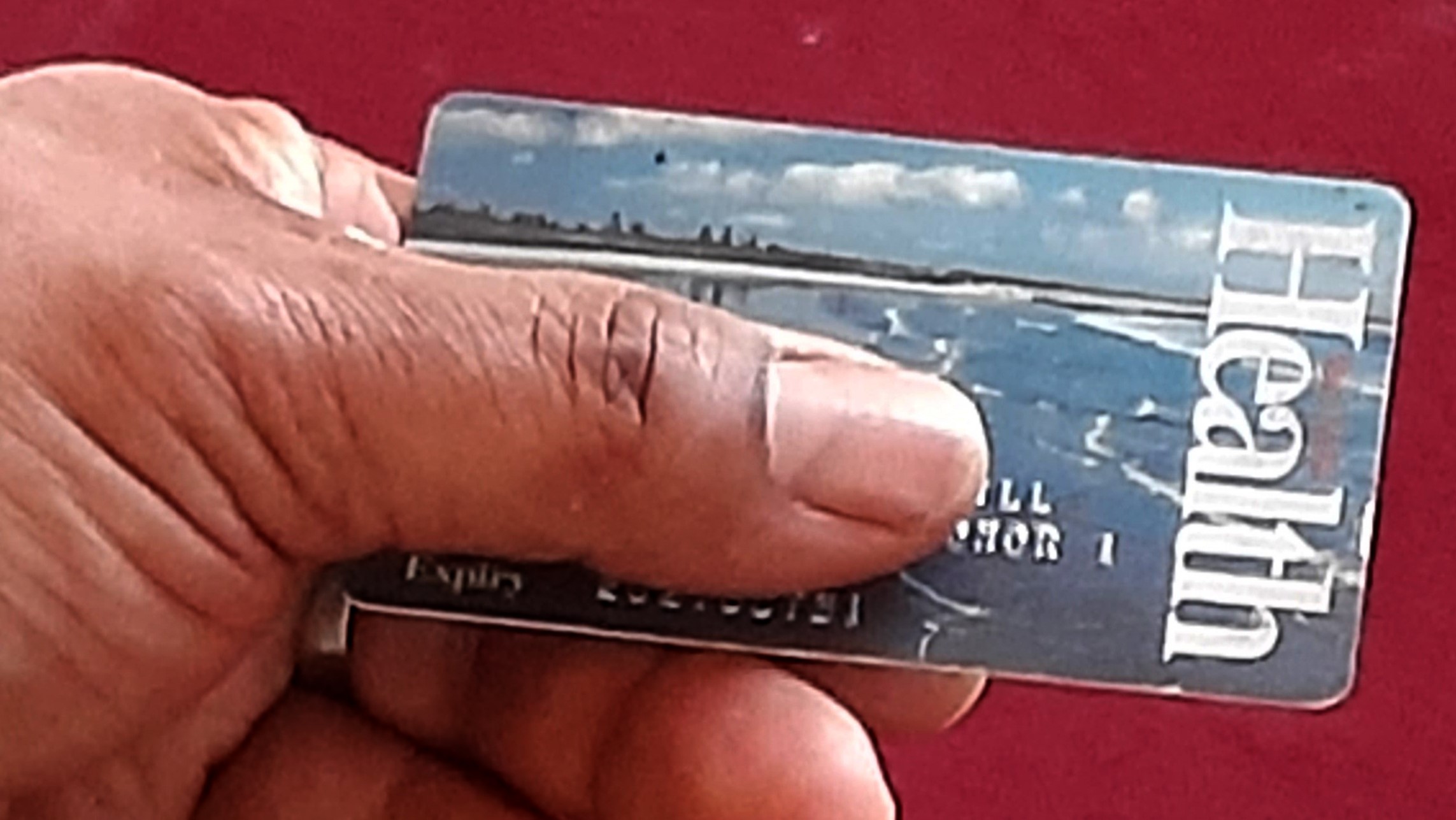 Photo illustration of person with health card. Health card numbers are being collected to develop race-based health data model in Nova Scotia.