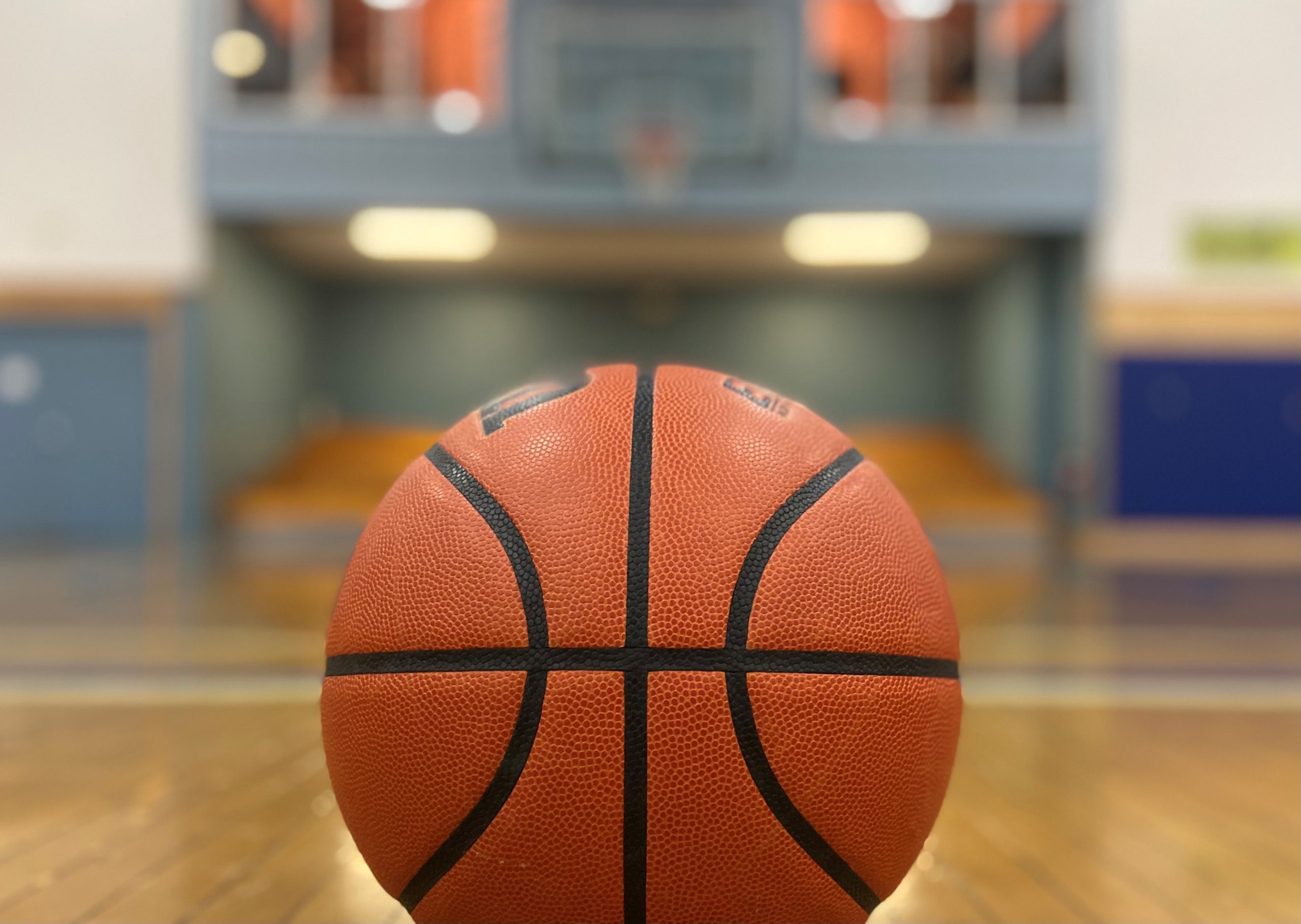 A basketball is seen on a basketball court.