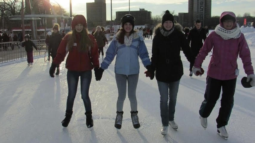 Cathy Targett (right) is pictured skating alongside international students she hosted, Sophie from Belgium (left), Carol from Brazil (middle left), and her daughter Cassandra (middle right).