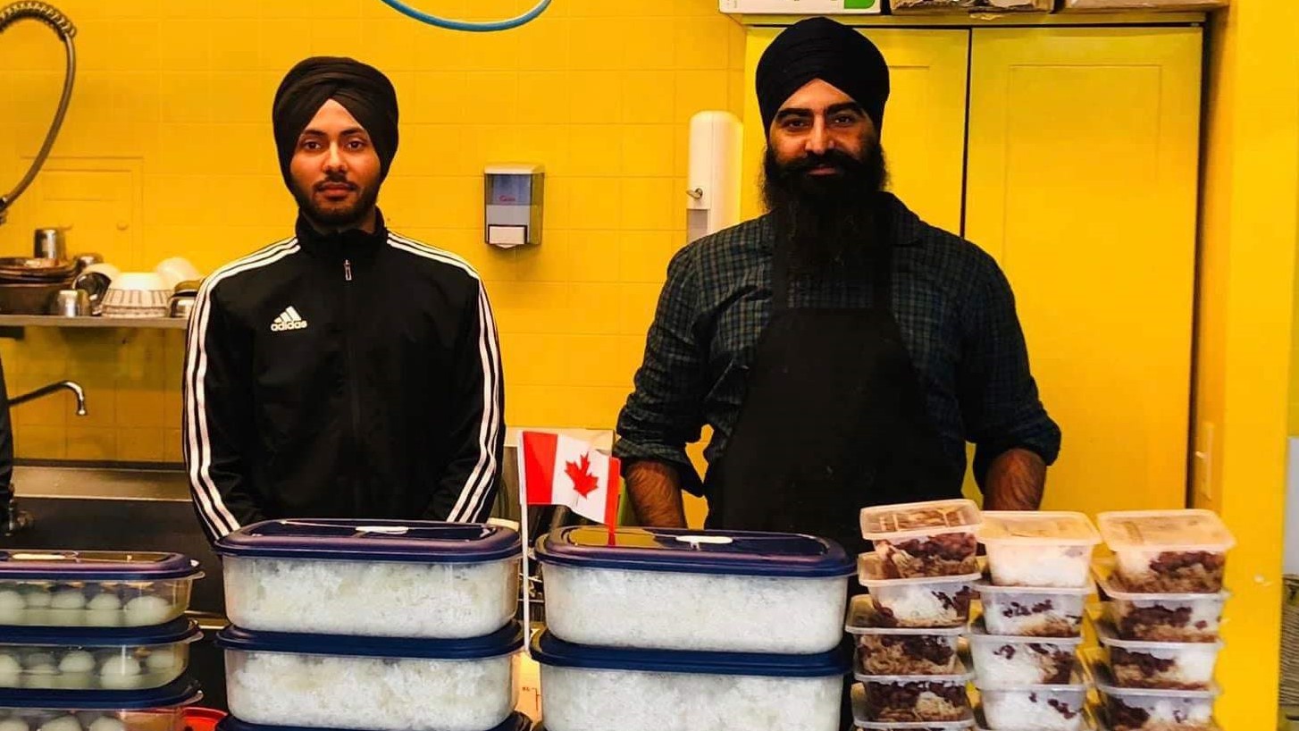 Volunteers from Maritime Sikh Society prepare meals to donate to the temporary shelter for the homeless at Gray Arena in Dartmouth.