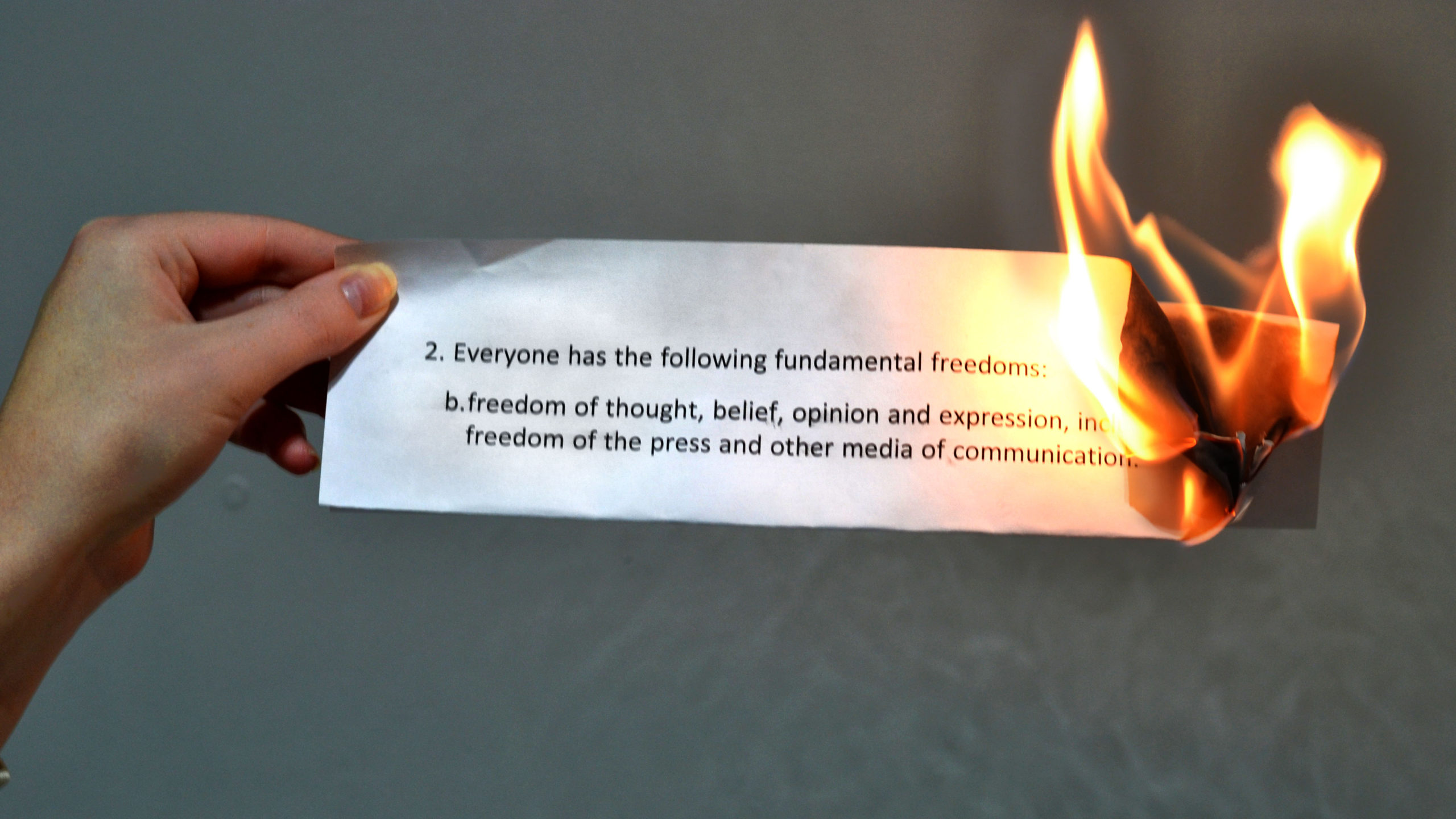 A person burns section two of the Canadian Charter of Rights and Freedoms.