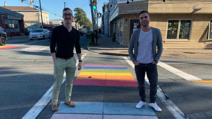 Nicholas Close (left) and Ian MacLeod (right) stand on a rainbow crosswalk in Halifax, October 2021.