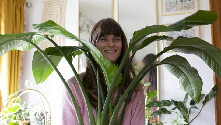 Sarah Wilson poses with her bird of paradise plant on Thursday.