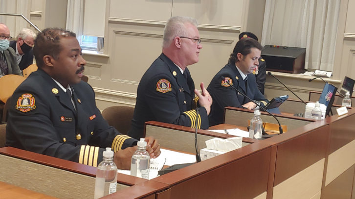 Fire Chief Kenneth Stuebing, centre, is flanked by deputy chief Corey Beals, left, and fire prevention chief Matt Covey as he speaks at Tuesday's council meeting.