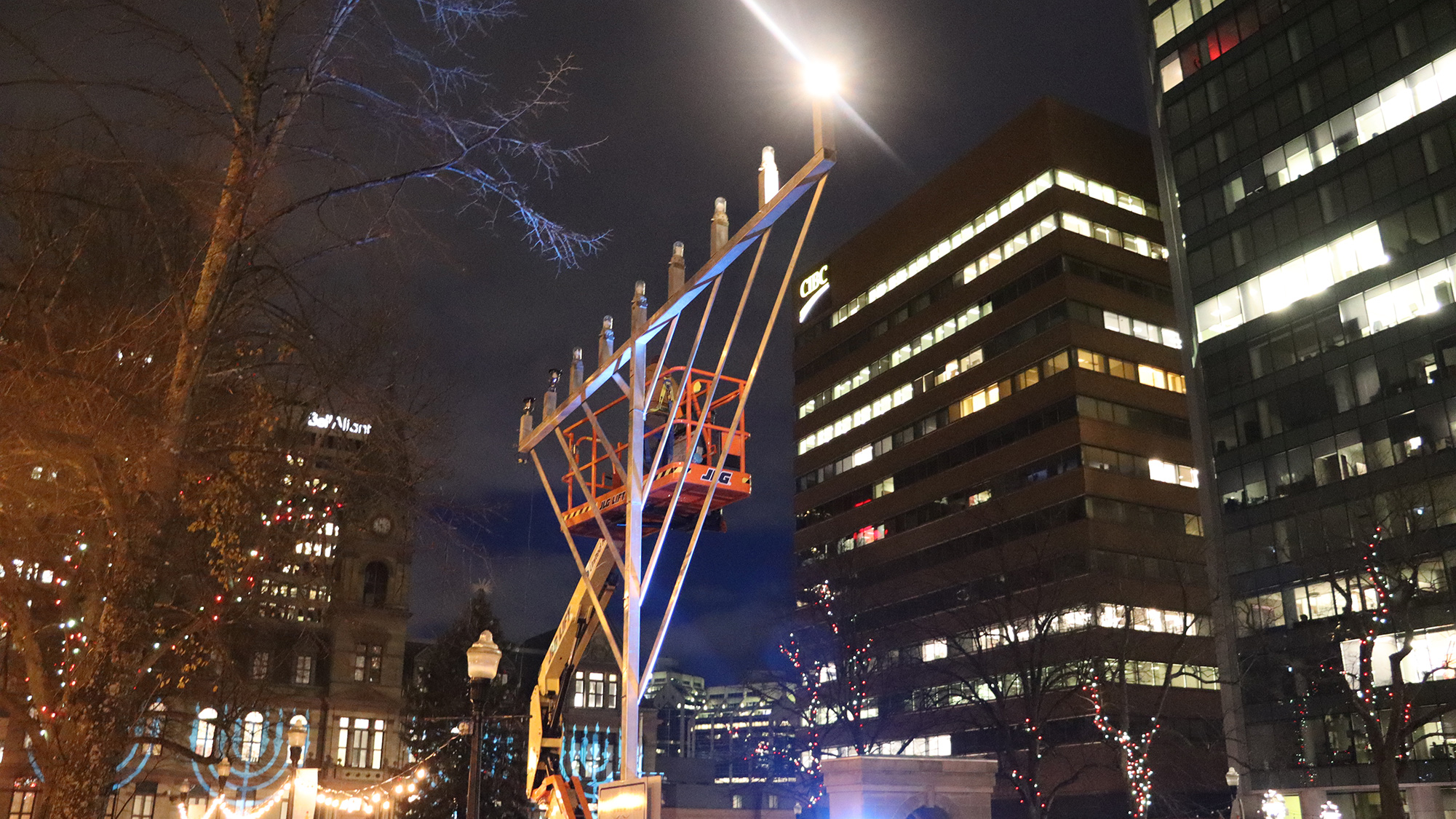 A city worker gets the big menorah ready for the annual menorah lighting, in Grand Parade in Halifax on Tuesday. 