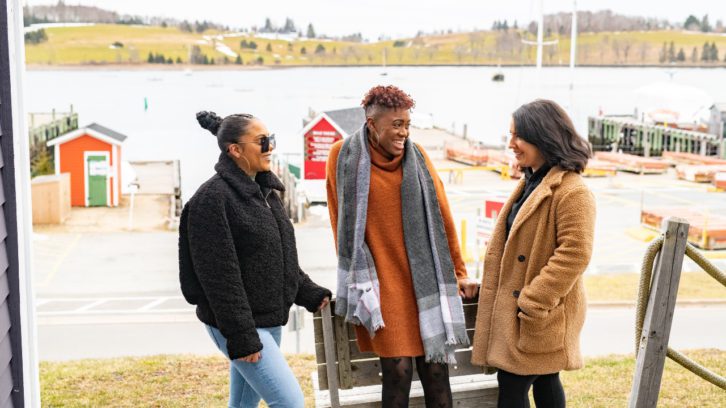 René Boudreau (left) and her friends Amber Grosse (middle) and Justine Murphy (right) pose in front of a South Shore waterfront. Boudreau is embarking on a project to promote Black Nova Scotia heritage for tourists.