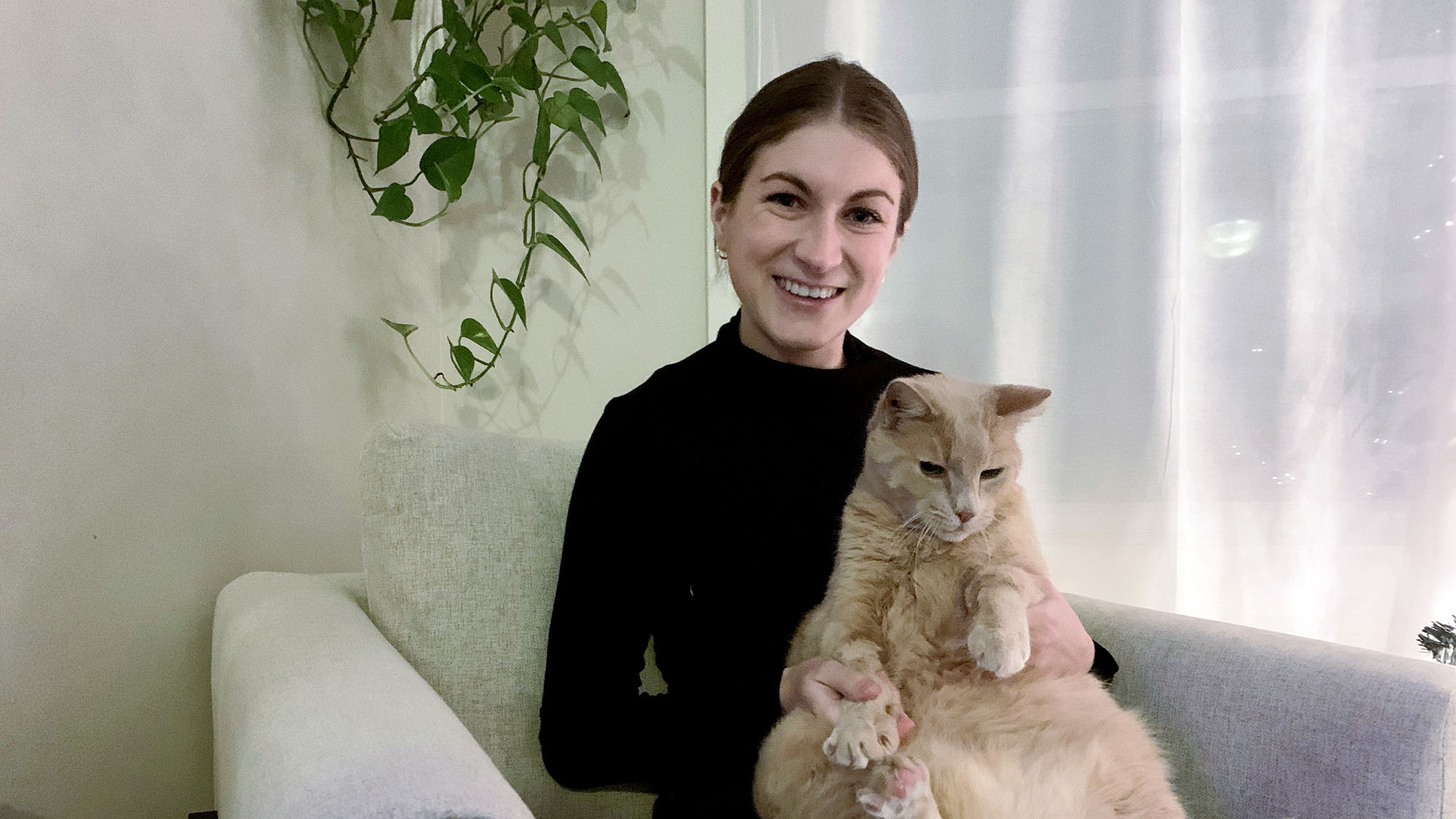 Angela Rafuse sits with her cat bo