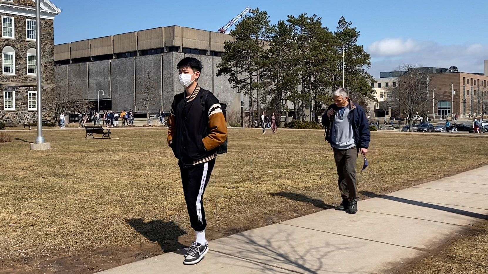 Dalhousie students and staff walk around campus, some with masks and some without. With the restrictions lifted on  March 21, 2022, masks will become optional at most locations in the province.