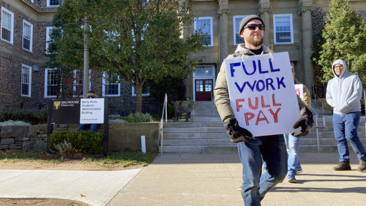 A CUPE 3912 striker pickets in front of the Henry Hicks Building at Dalhousie University on Nov. 9. The union reached a tentative agreement with Dal a day earlier. 