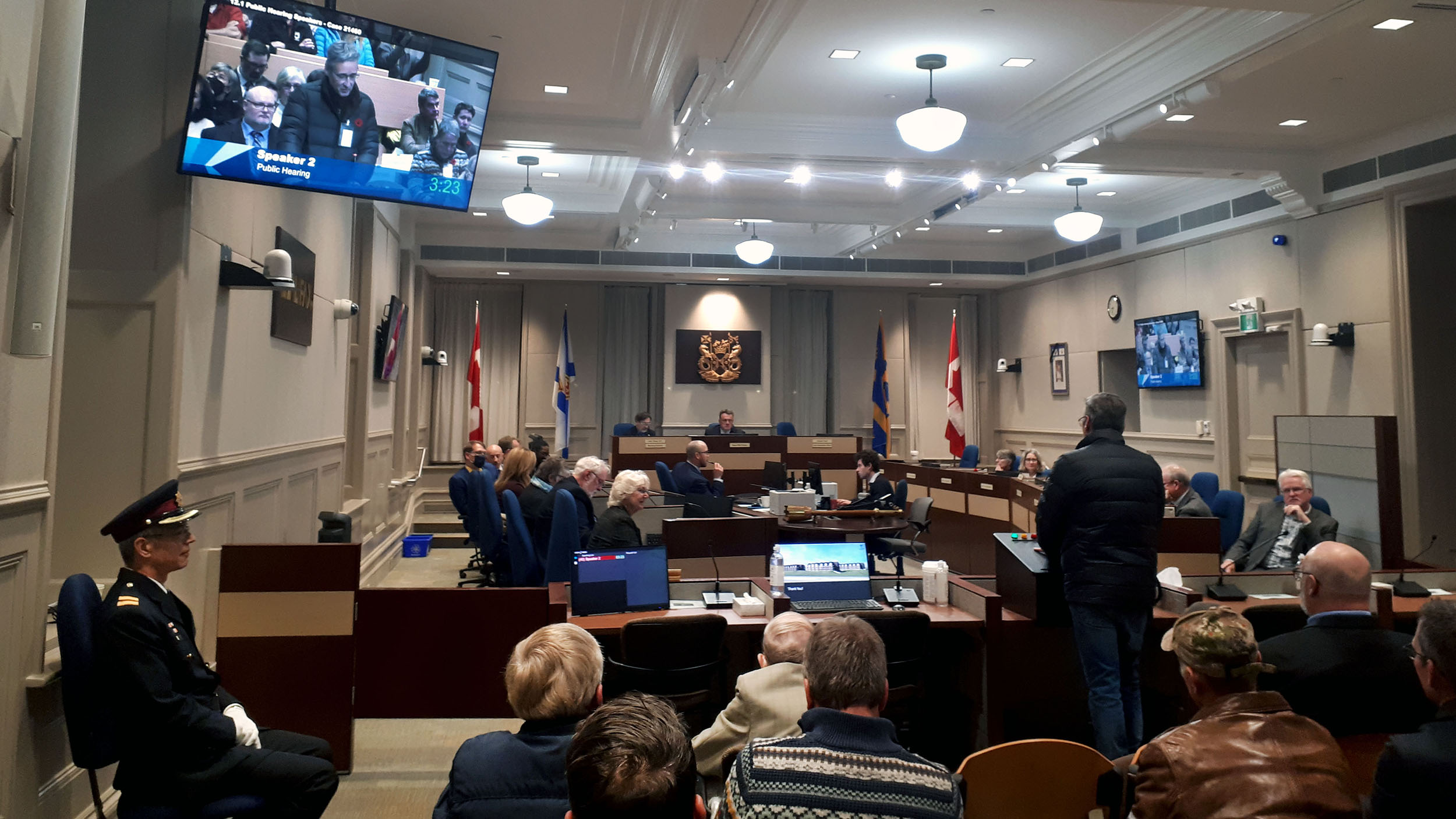 Council public hearing with a presenter at the front of the room