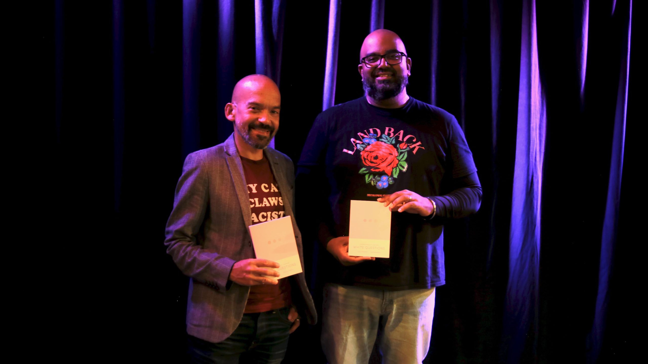 Ajay Parasram (left) and Alex Khasnabish (right) hold up their new book, Frequently Asked White Questions, at their book launch held at the Bus Stop Theatre on Nov. 8 in Halifax.
